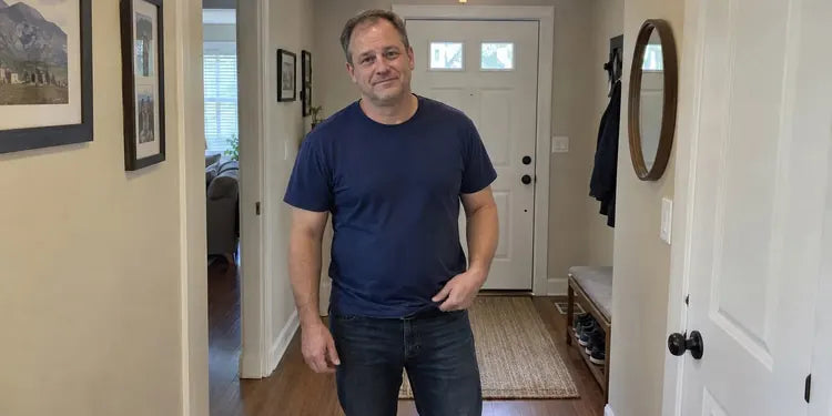 Illustrative scene of an ordinary middle-aged man adjusting his T-shirt in his hallway