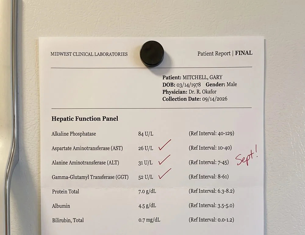 Gary's September 14 liver panel on the fridge: AST 26, ALT 31, GGT 52, all in range