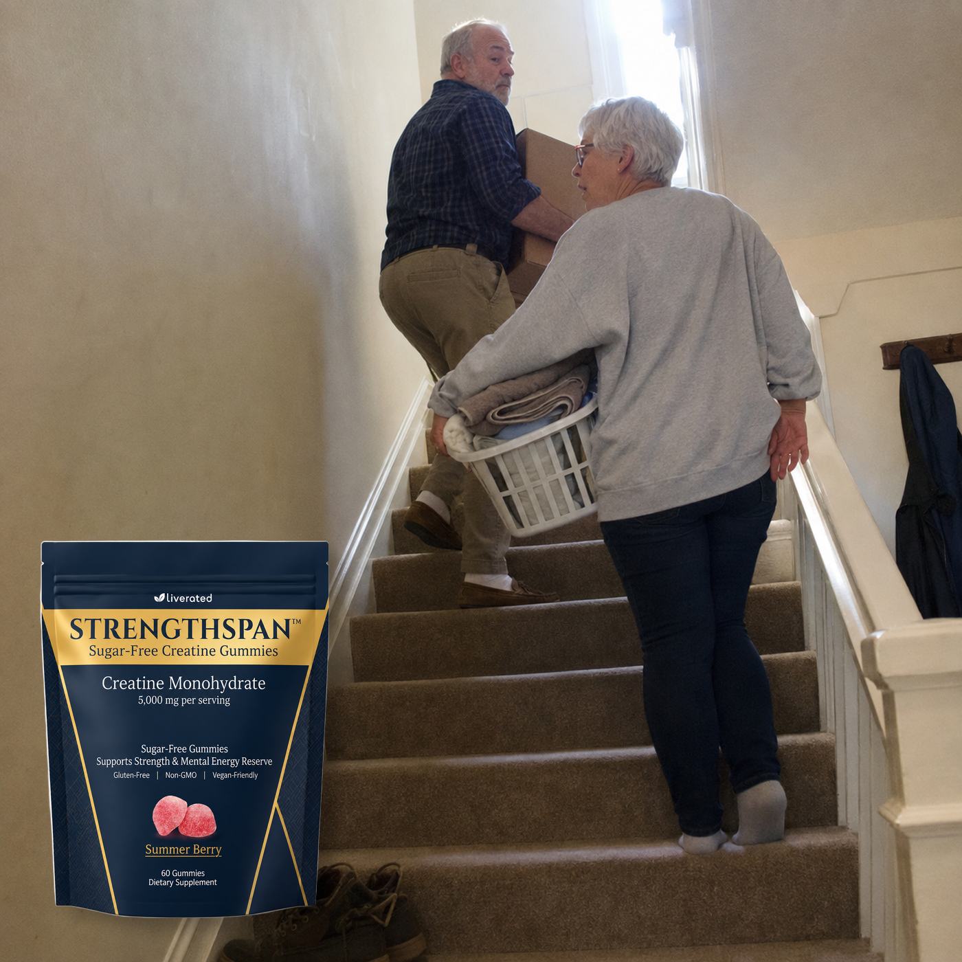 Couple in their late 50s carrying a box up the stairs at home without the rail